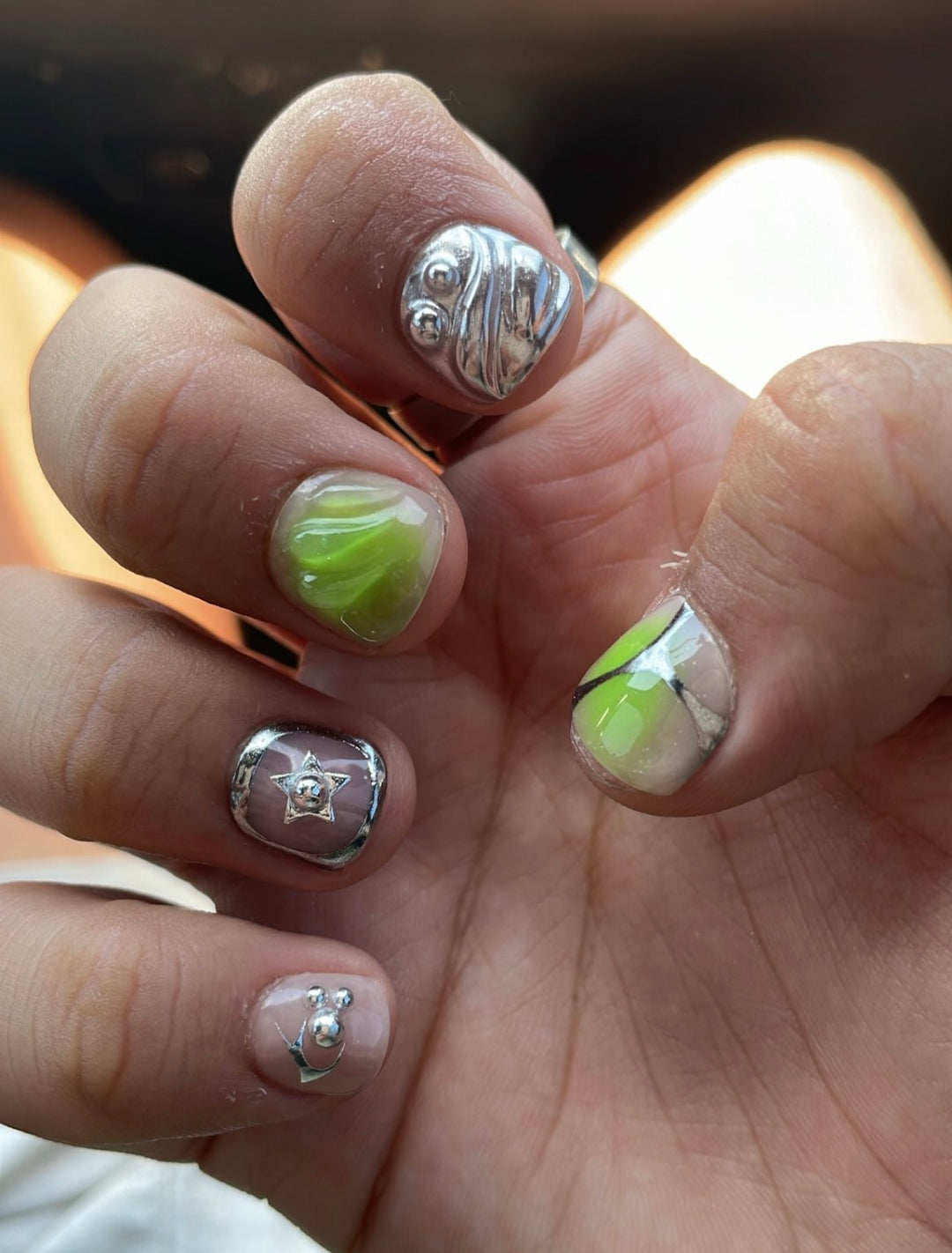 Shown in “MAN-I cure length - available in any. Aurora ombré and 3D blob designs with chrome stars and  bezels.  Rockstar look available in any length or most color combo of your choice.