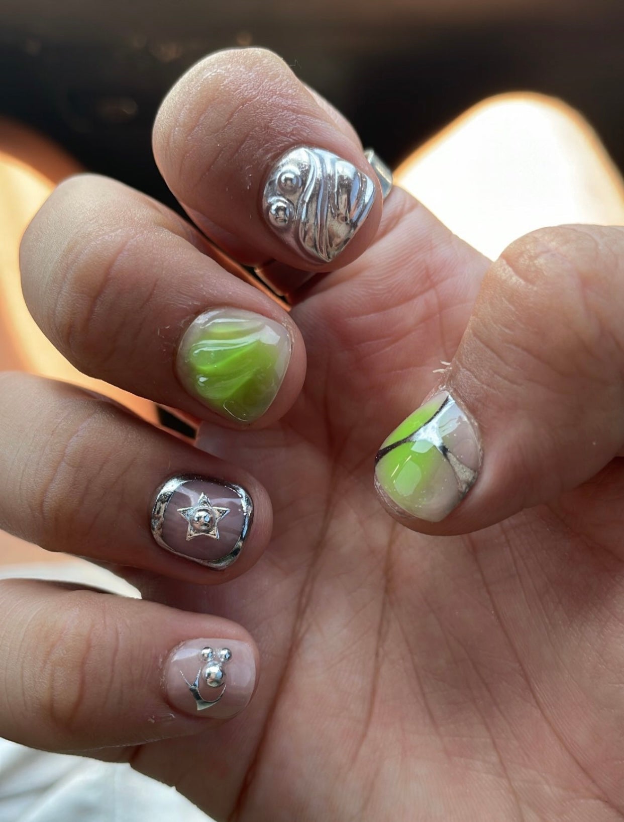 Shown in “MAN-I cure length - available in any. Aurora ombré and 3D blob designs with chrome stars and  bezels.  Rockstar look available in any length or most color combo of your choice.