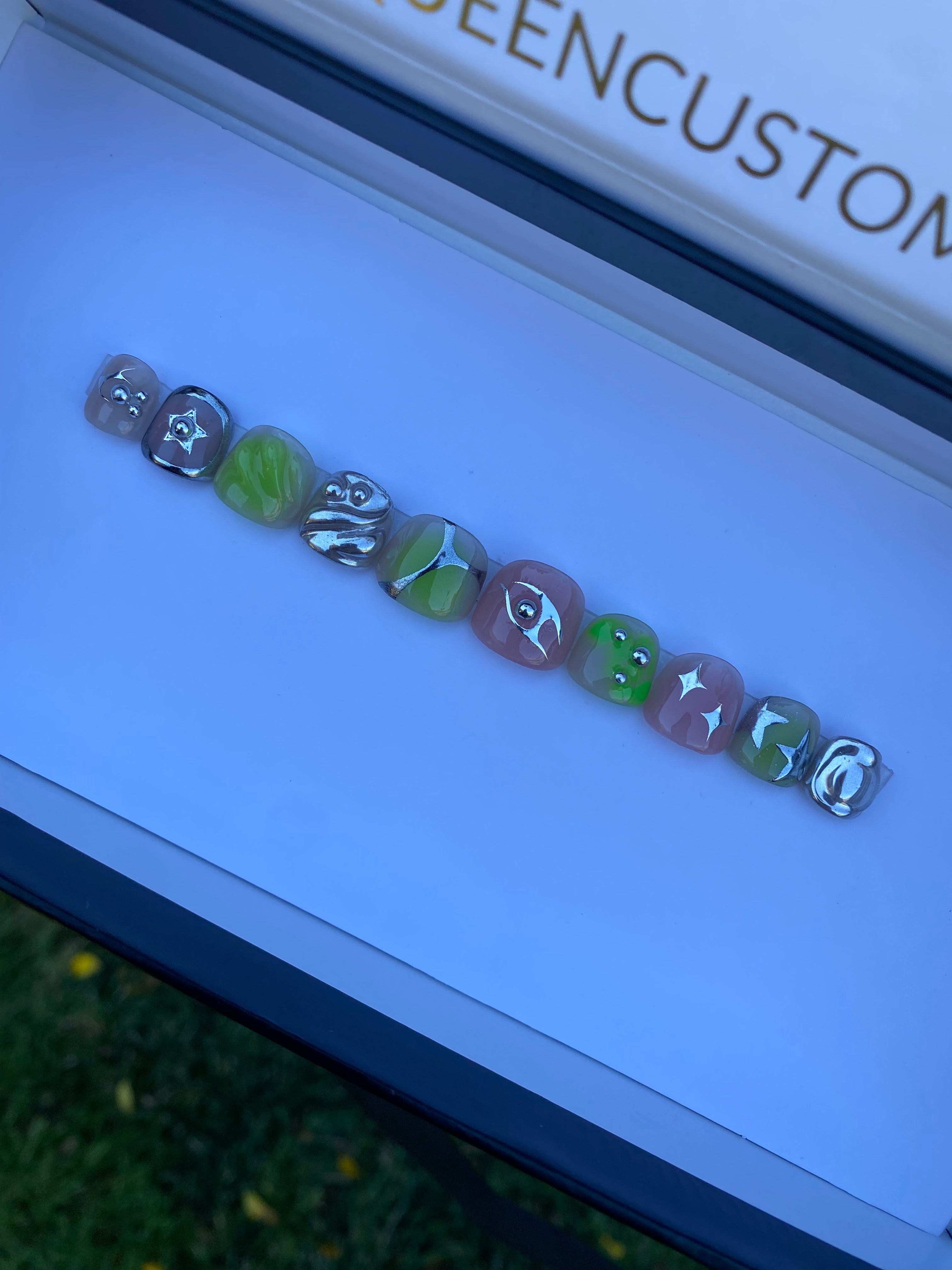 Shown in “MAN-I cure length - available in any. Aurora ombré and 3D blob designs with chrome stars and  bezels.  Rockstar look available in any length or most color combo of your choice.
