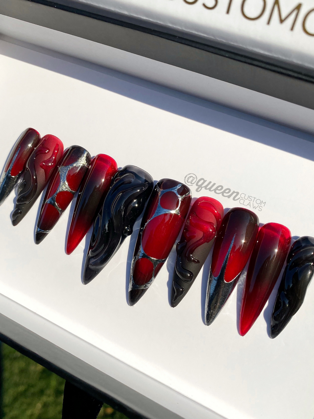 a close up of a red and black halloween press on nails