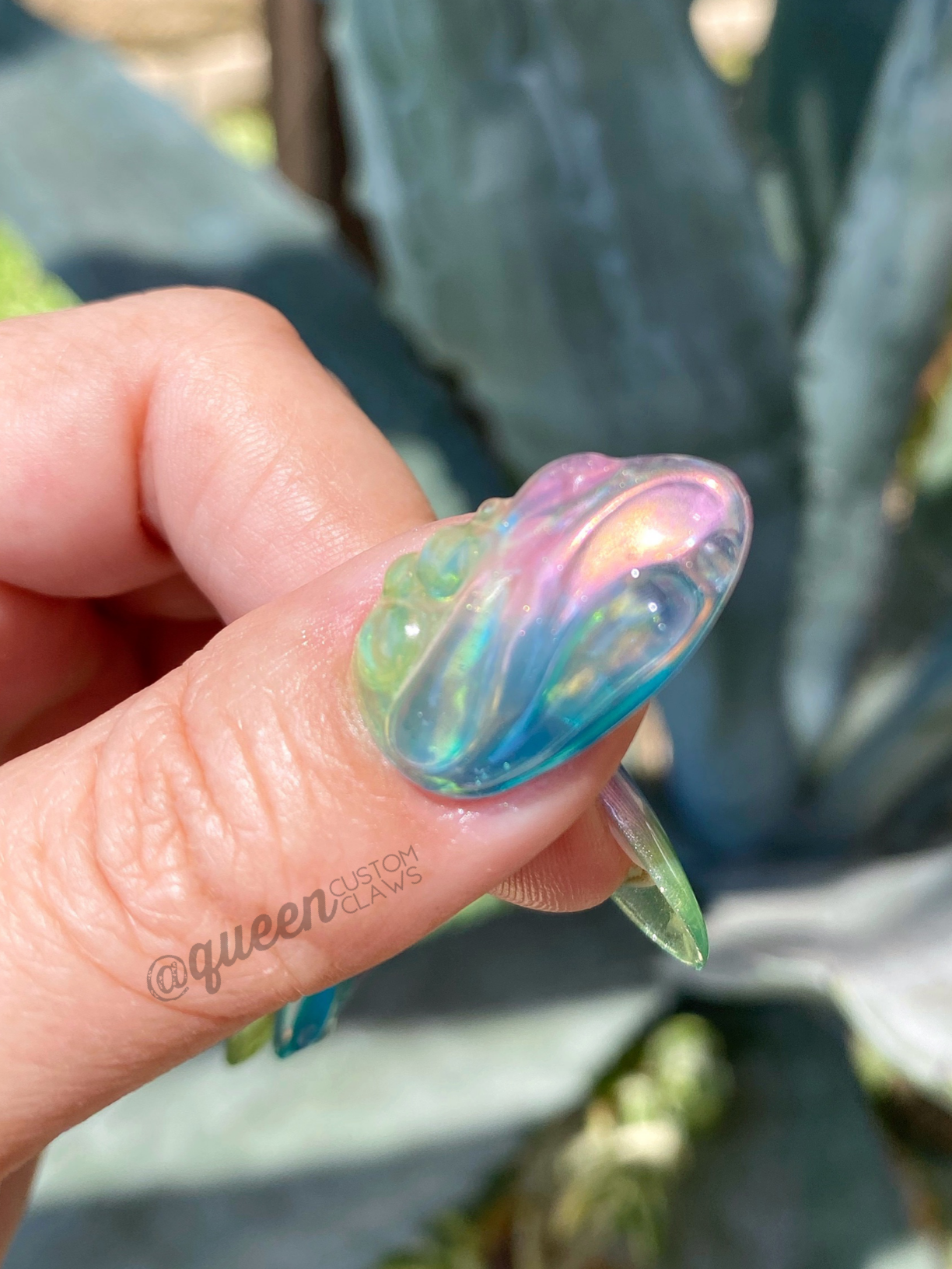 a person showing 3d swirly press on nails on their hand