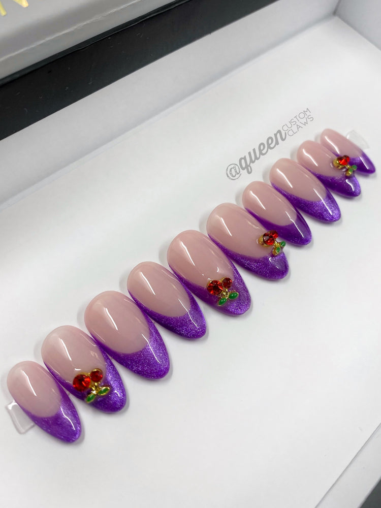 a display case with purple and pink press on nails
