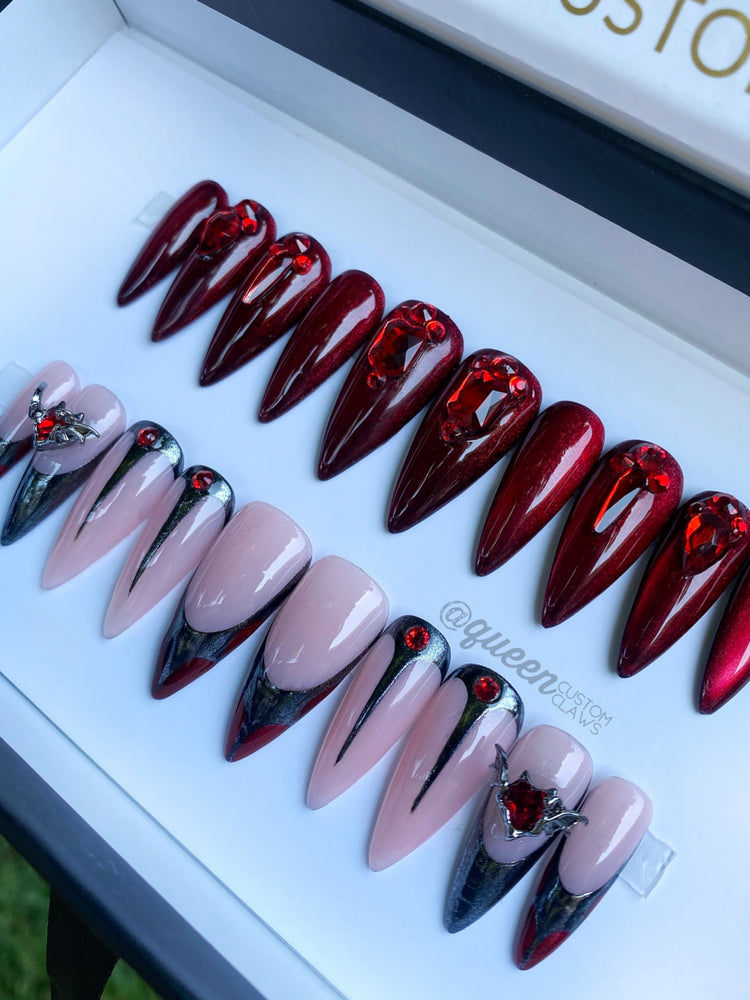 a display of red and black stiletto press on instant acrylic nails