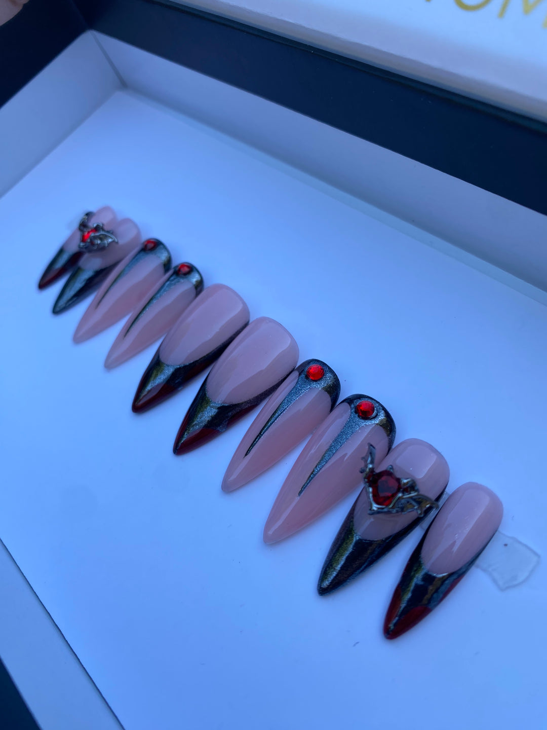 nude chrome and black French tip nails with 3d bat shaped gems. instant acrylic press on nails shown in a modern gothic style, featuring negative space