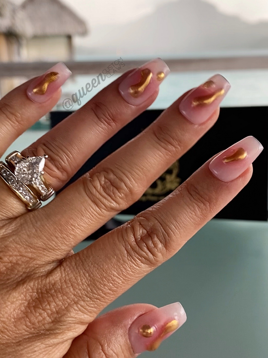 a woman's hand with a ring on it displaying 3d blob press on nails