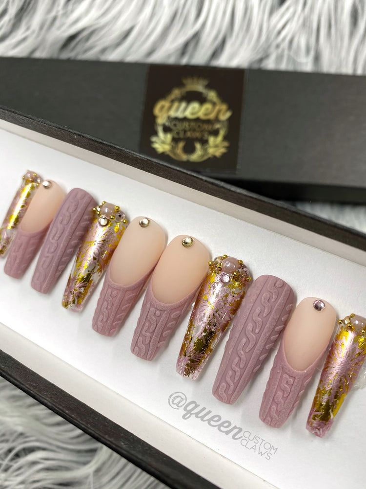 a display of pink and gold press on nails in a box
